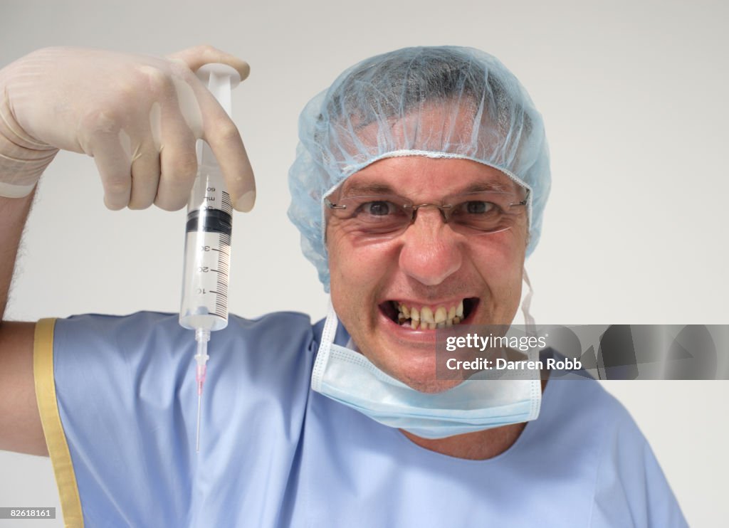 Surgeon Holding A Scringe Menacingly High-Res Stock Photo - Getty Images