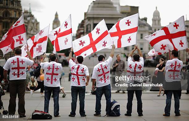 Georgians hold up their country's flag as they gather to voice their opinions during an anti-Russian protest at Trafalgar Square on September 1, 2008...