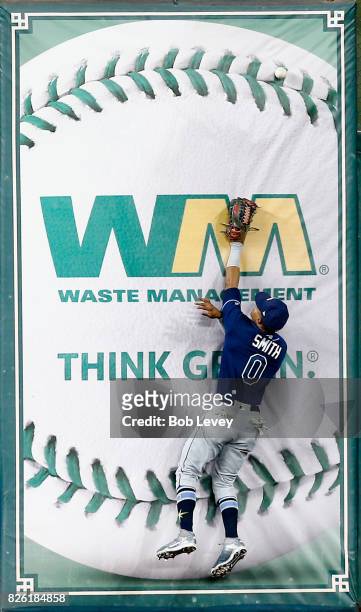 Mallex Smith of the Tampa Bay Rays leaps at the wall but is unable to catch a fly ball by Yuli Gurriel of the Houston Astros in the first inning at...