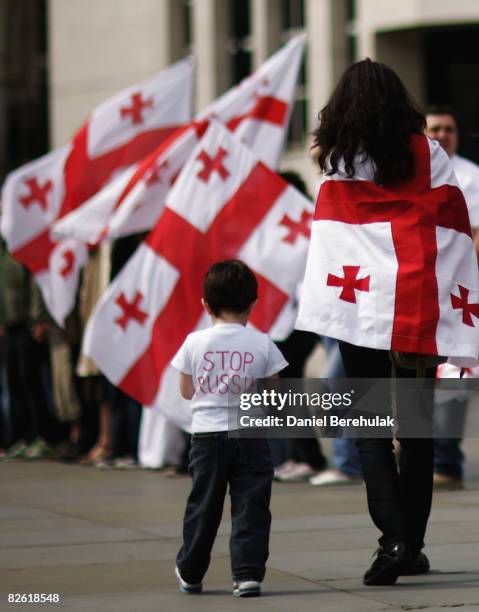 Georgians hold up their country's flag as they gather to voice their opinions during an anti-Russian protest at Trafalgar Square on September 1, 2008...