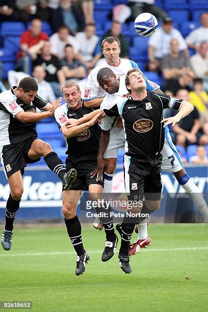 Bas Savage and Antony Kay of Tranmere Rovers challenge for the ball with Giles Coke, Andy Holt and Chris Doig of Northampton Town during the Coca...