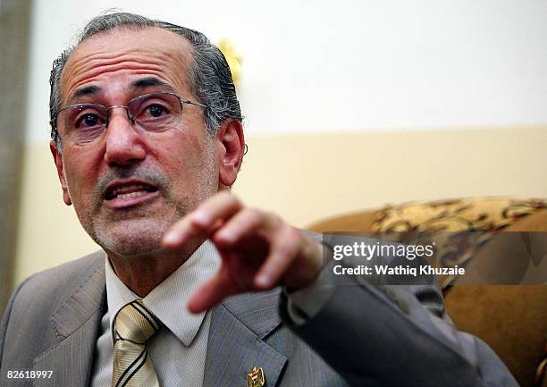 Iraq's national security adviser Muwafaq al-Rubaie speaks during a meeting before the start of a handover ceremony at the government headquarters...