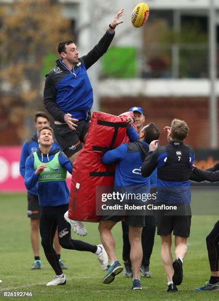 Todd Goldstein of the Kangaroos taps the ball away during a North Melbourne Kangaroos AFL training session at Arden Street Ground on August 4, 2017...