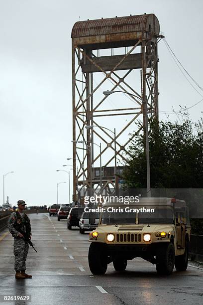 Member of the U.S. Army National Guard stops traffic over the Industrial canal bridge as Hurricane Gustav strikes the Gulf Coast September 1, 2008 in...