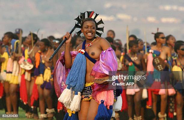 Leader of the maidens dances in front of King Mswati III and his delegates during an annual traditional reed dance at Ludzidzini palace outside the...