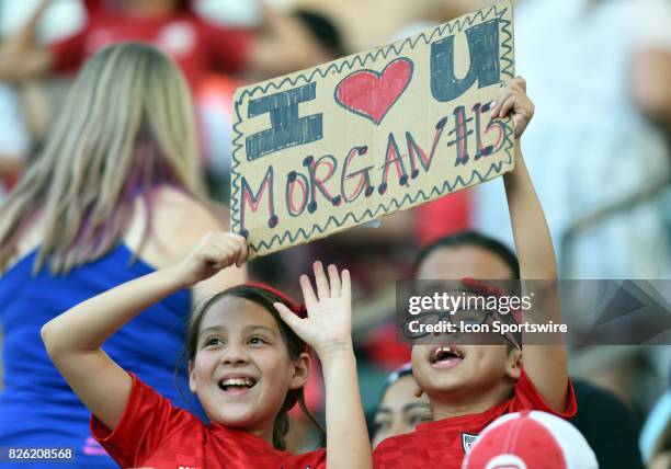 Two young USA fans hold up a sign in support Alex Morgan of USA during the Tournament of Nations soccer match between USA and Japan on August 03,...