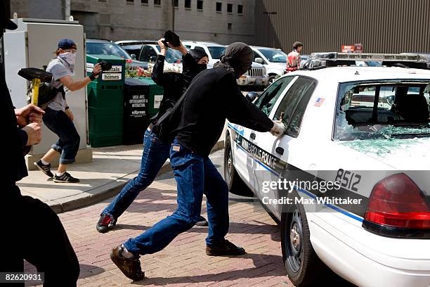 Protestors vandalize police cars in the streets outside the Republican National Convention at the Xcel Energy Center September 1, 2008 in St. Paul,...