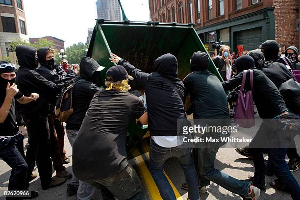 Protestors tip over a dumpster in the streets outside the Republican National Convention at the Xcel Energy Center September 1, 2008 in St. Paul,...