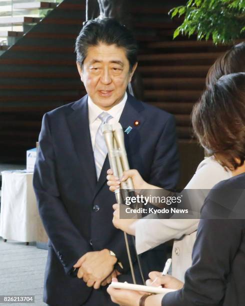 Japanese Prime Minister Shinzo Abe answers questions from reporters in his office in Tokyo on Aug. 4 a day after he reshuffled his Cabinet. ==Kyodo