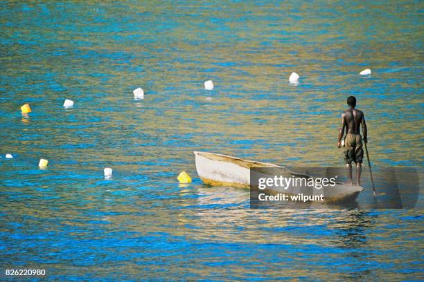 fisherman on dugout canoe - lake victoria stock pictures, royalty-free photos & images