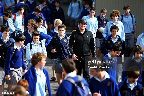 Tony Woodcock of the All Blacks walks with students during a community visit to Francis Douglas Memorial College prior to the New Zealand All Blacks...