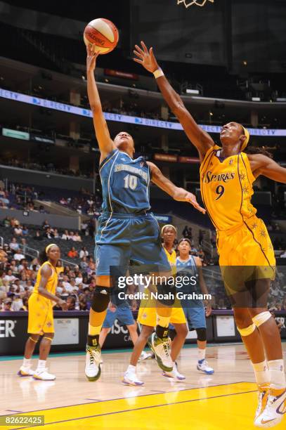 Lindsey Harding of the Minnesota Lynx attempts a shot against Lisa Leslie of the Los Angeles Sparks at Staples Center on September 1, 2008 in Los...