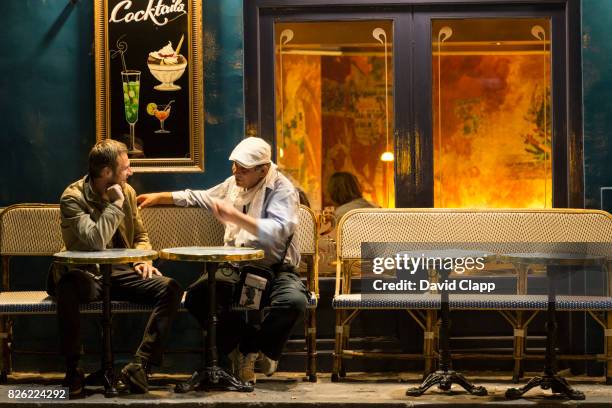 late night conversations outside a cafe in montmartre - café paris stock pictures, royalty-free photos & images