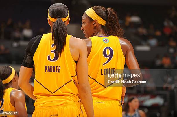 Candace Parker and Lisa Leslie of the Los Angeles Sparks stand together during a break in the action of their game against the Minnesota Lynx at...