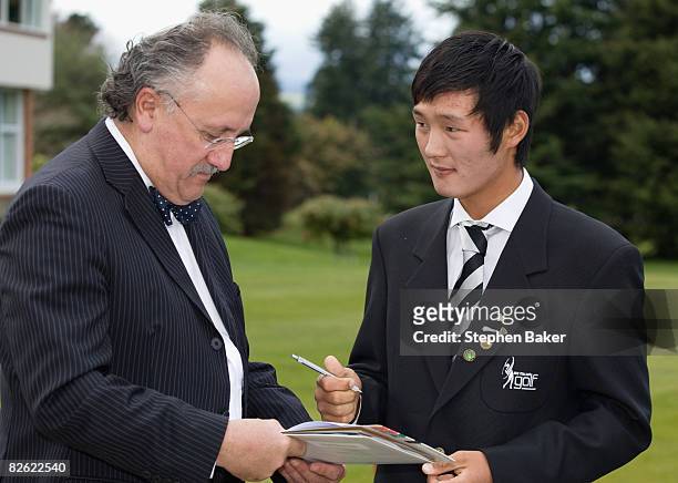 Amateur golfer Danny Lee of New Zealand signs official documents with solicitor Ian Blackwell after his New Zealand Citizenship Ceremony at the...