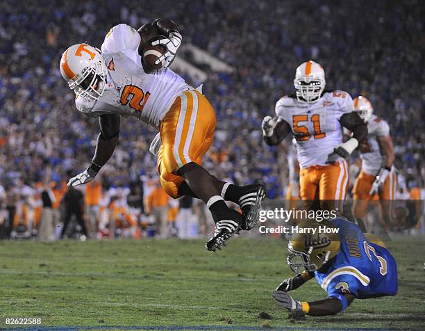 Montario Hardesty of the Tennessee Volunteers jumps over the tackle of Rahim Moore of the UCLA Bruins to score a touchdown for a 21-17 lead during...