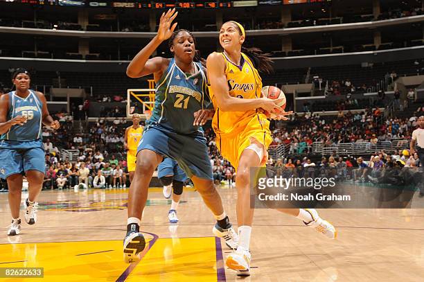 Candace Parker of the Los Angeles Sparks goes hard to the basket against the defense of Nicky Anosike of the Minnesota Lynx at Staples Center on...