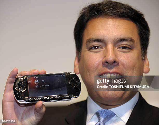 Sony Computer Entertainment Japan President Shawn Layden shows off the company's new PlayStation Portable handheld game console, the PSP-3000 during...