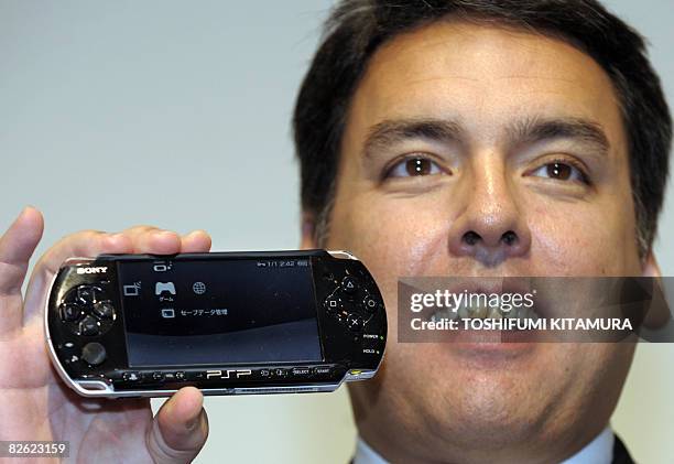 Sony Computer Entertainment Japan President Shawn Layden shows off the company's new PlayStation Portable handheld game console, the PSP-3000 during...