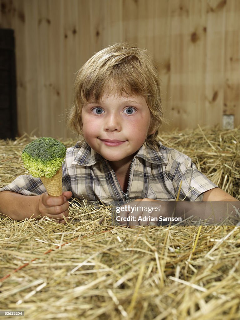 Boy holding 'ice cream' made from broccoli