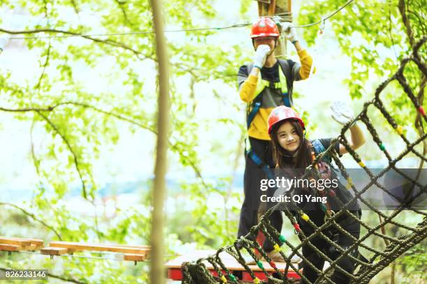 young female climber in forest ,china - abseiling stock pictures, royalty-free photos & images