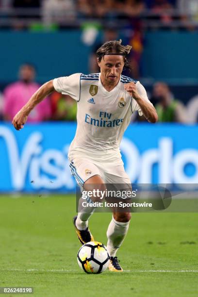 Real Madrid midfielder Luka Modric in action during the first half of the International Champions Cup match against Barcelona at Hard Rock Stadium in...