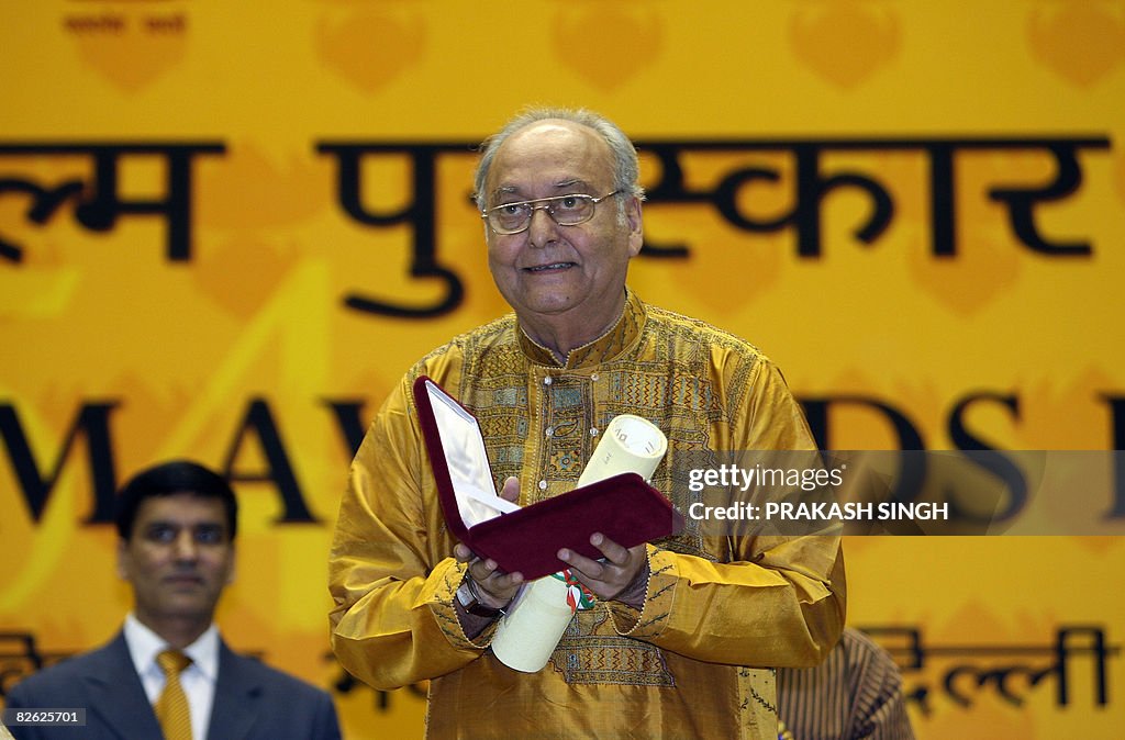 Soumitra Chatterjee poses after receivei