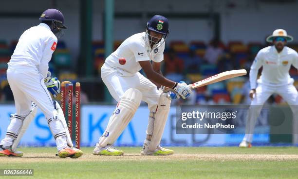 Indian cricketer Ravichandran Ashwin is bowled out as Sri Lankan wicket keeper Niroshan Dickwella looks on during the 2nd Day's play in the 2nd Test...