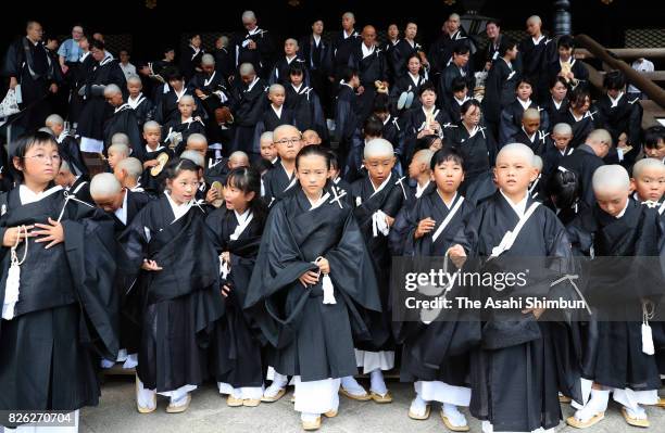 Children with shaven heads and wearing Kesa, monk costumes attend 'Tokudo-Shiki' a ceremony to become Buddhist monks at Higashi Honganji temple on...