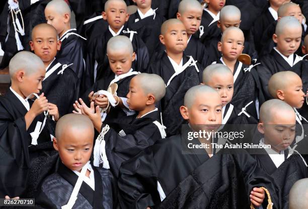 Children with shaven heads and wearing Kesa, monk costumes attend 'Tokudo-Shiki' a ceremony to become Buddhist monks at Higashi Honganji temple on...