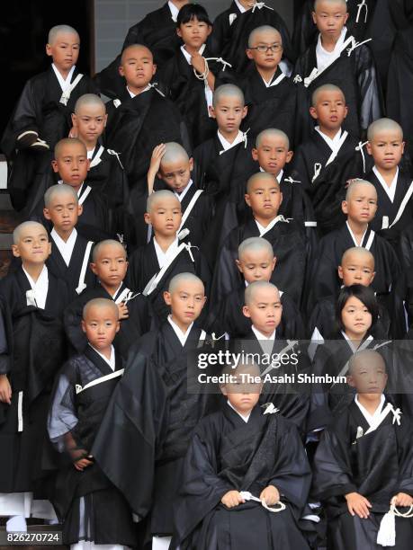 Children with shaven heads and wearing Kesa, monk costumes attend 'Tokudo-Shiki' a ceremony to become Buddhist monks at Higashi Honganji temple on...