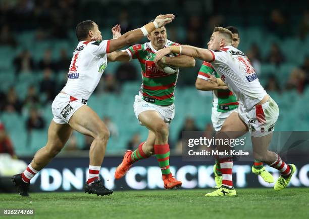 Bryson Goodwin of the Rabbitohs attempts to get past his opponents during the round 22 NRL match between the St George Illawarra Dragons and the...