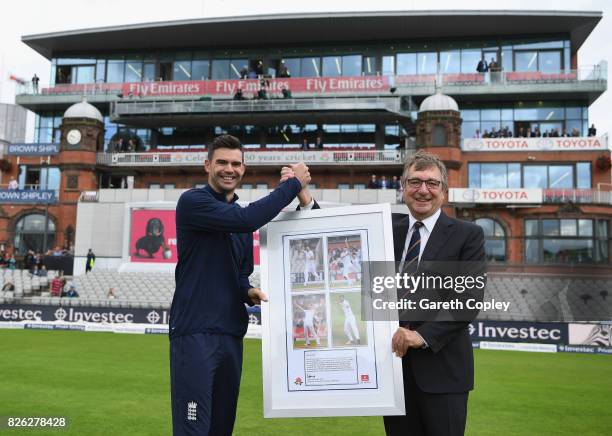 David Hodgkiss, Chairman of Lancashire CCC presents James Anderson of England with a framed photo after the naming of the James Anderson End during...