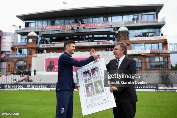 David Hodgkiss, Chairman of Lancashire CCC presents James Anderson of England with a framed photo after the naming of the James Anderson End during...