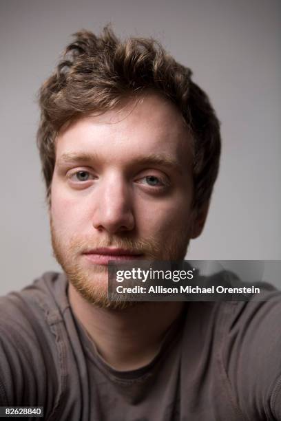 portrait of young male looking at camera - studio head shot serious confident looking at camera foto e immagini stock