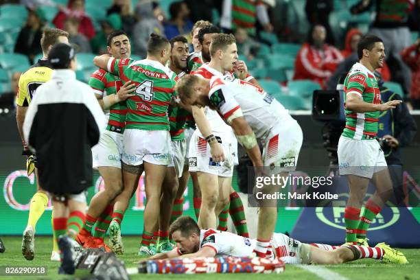 Bryson Goodwin of the Rabbitohs celebrates with his team mates after scoring a try late in the match to level the scores during the round 22 NRL...