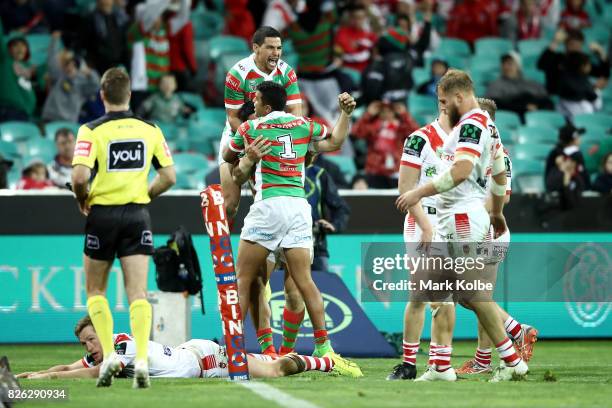 Cody Walker and Alex Johnston of the Rabbitohs celebrate with Bryson Goodwin of the Rabbitohs after he scored a try to level the socres late in the...