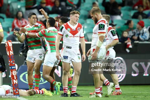 Bryson Goodwin of the Rabbitohs celebrates with his team mates after scoring a try late in the match to level the scores during the round 22 NRL...