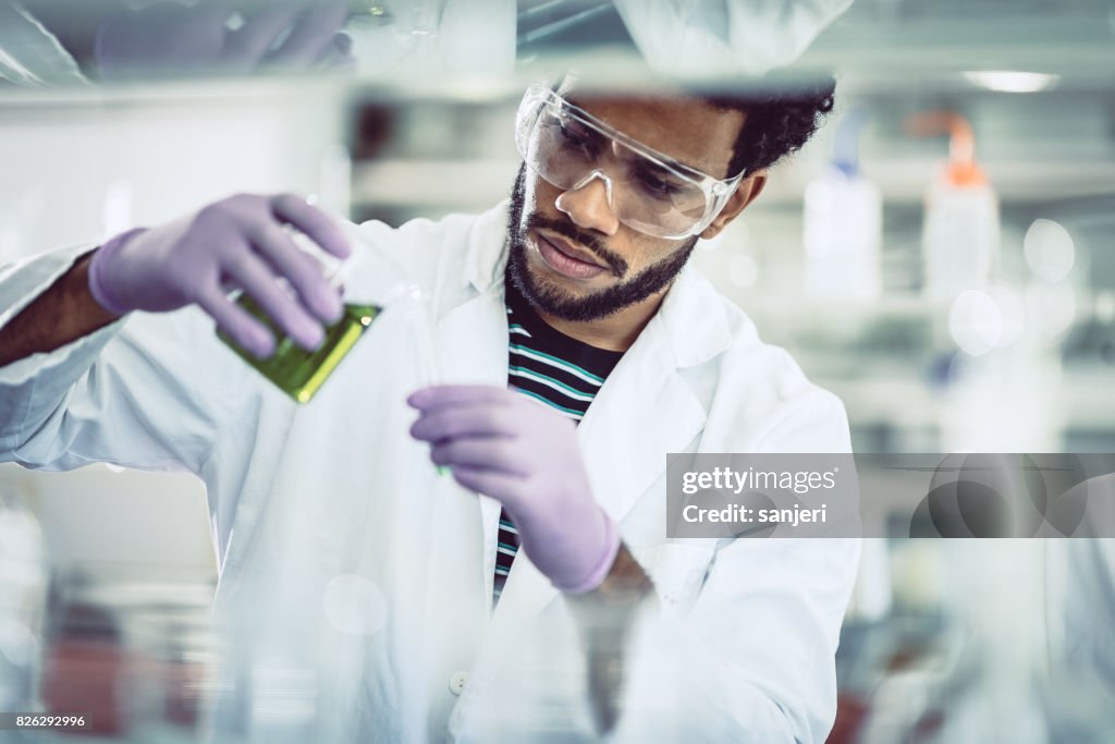 Scientist Pouring Reagent into Test tube