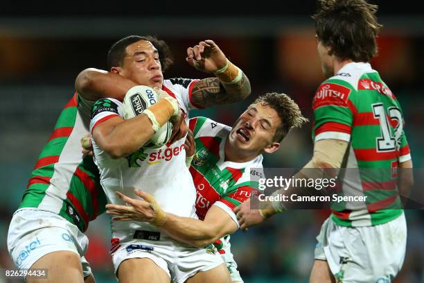 Tyson Frizzle of the Dragons is tackled during the round 22 NRL match between the St George Illawarra Dragons and the South Sydney Rabbitohs at...