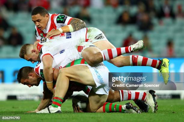 Cameron Murray of the Rabbitohs is tackled during the round 22 NRL match between the St George Illawarra Dragons and the South Sydney Rabbitohs at...