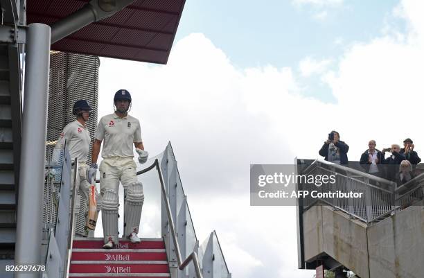 England's Keaton Jennings and England's Alastair Cook leave the pavilion on the first day of the fourth test at Old Trafford Cricket Ground in...