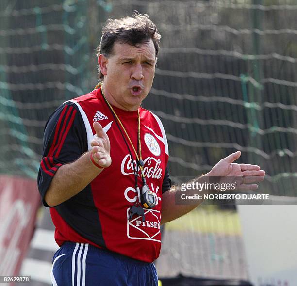 Argentine coach of the Paraguayan national football team, Gerardo "Tata" Martino, gives instructions to his players during a training session in...