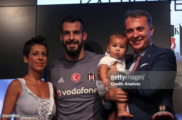Besiktas' new transfer Alvaro Negredo Sanchez poses for a photo with his baby, his wife Amparo Moreno and Besiktas' President Fikret Orman during a...