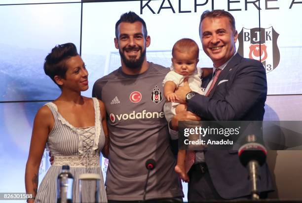 Besiktas' new transfer Alvaro Negredo Sanchez poses for a photo with his baby, his wife Amparo Moreno and Besiktas' President Fikret Orman during a...