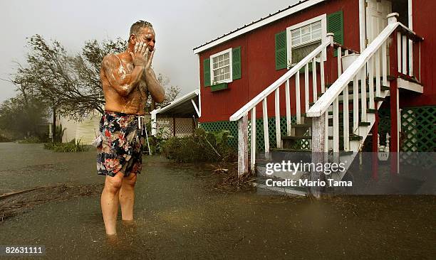 Mark Colwart takes a makeshift bath in the floodwaters from Hurricane Gustav in front of his home September 2, 2008 in Chauvin, Louisiana. Colwart...