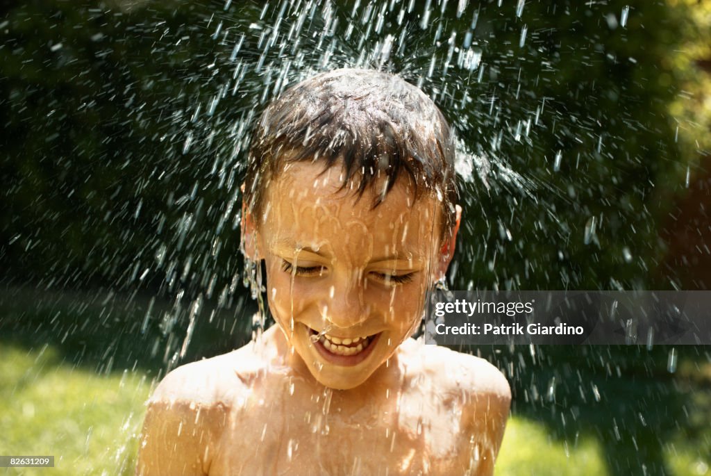 Boy Getting Splashed With Water High-Res Stock Photo - Getty Images
