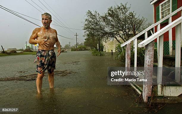 Mark Colwart takes a makeshift bath in the floodwaters from Hurricane Gustav in front of his home September 2, 2008 in Chauvin, Louisiana. Colwart...