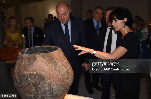 French Minister of Agriculture Stéphane Travert looks at a terracotta wine jar or kvevris from Georgia dating from 6BC which sits on display at an...