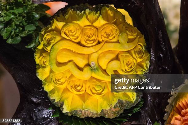 Carved pumpkin is displayed during a fruit and vegetable carving competition in Bangkok on August 4, 2017. It is a royal tradition that has proved...